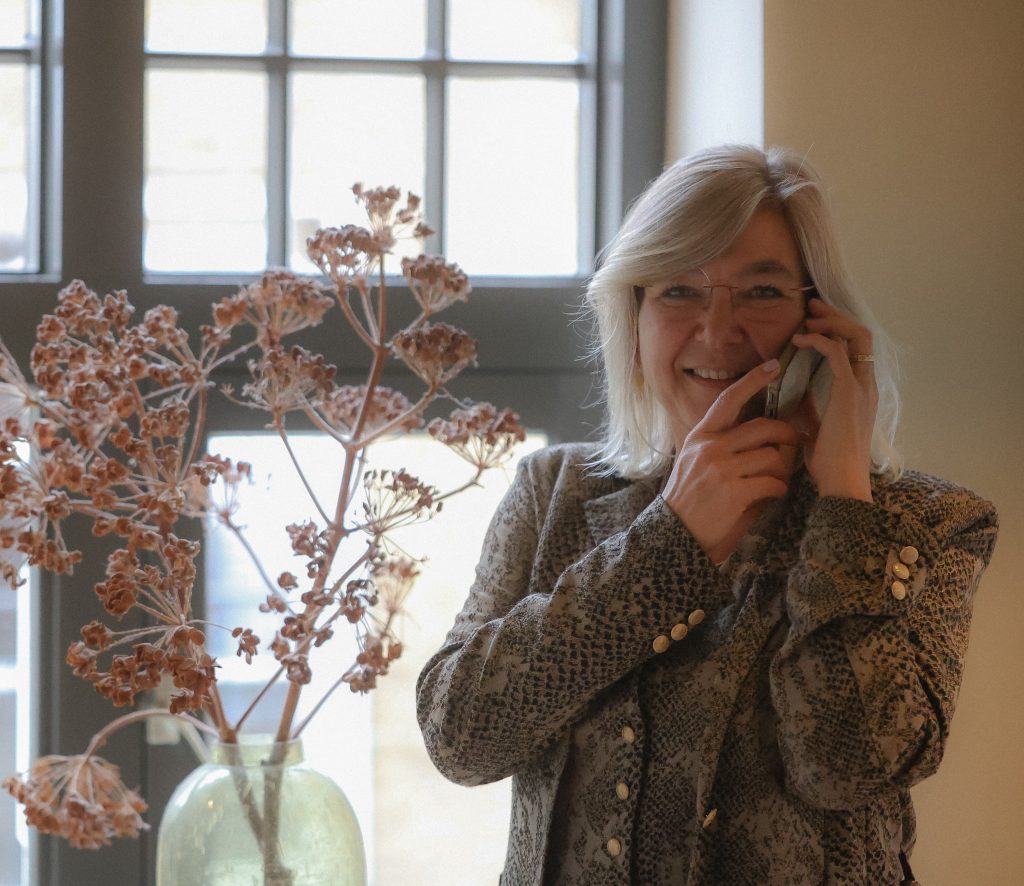 Melanie van De MEL Methode voert een telefoongesprek.